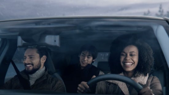 Three passengers riding in a vehicle and smiling | Mitchell Nissan in Enterprise AL