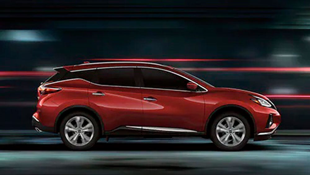 2023 Nissan Murano shown in profile driving down a street at night illustrating performance. | Mitchell Nissan in Enterprise AL